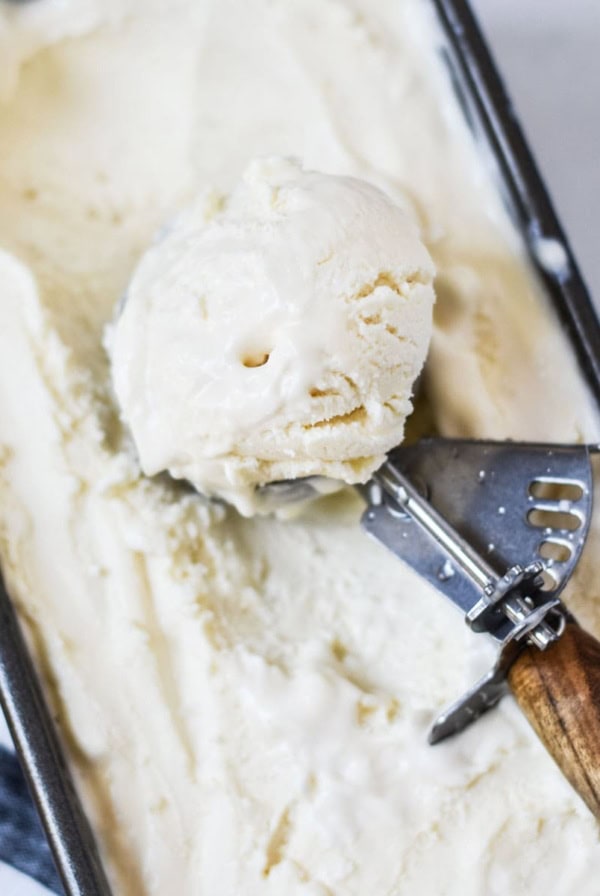 A big ice cream scoop full of mascarpone ice cream.