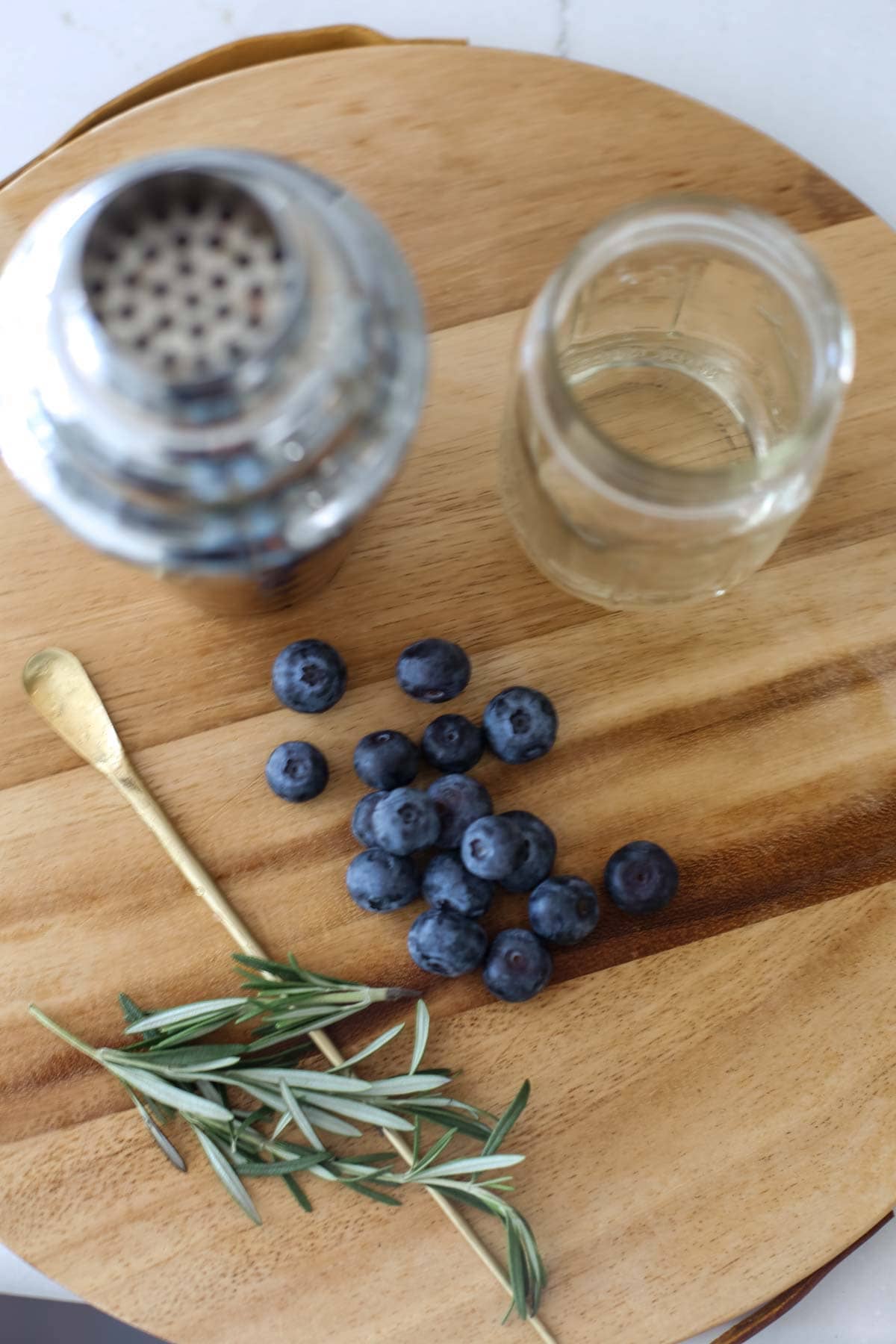 Blueberries, rosemary, and agave on a table.
