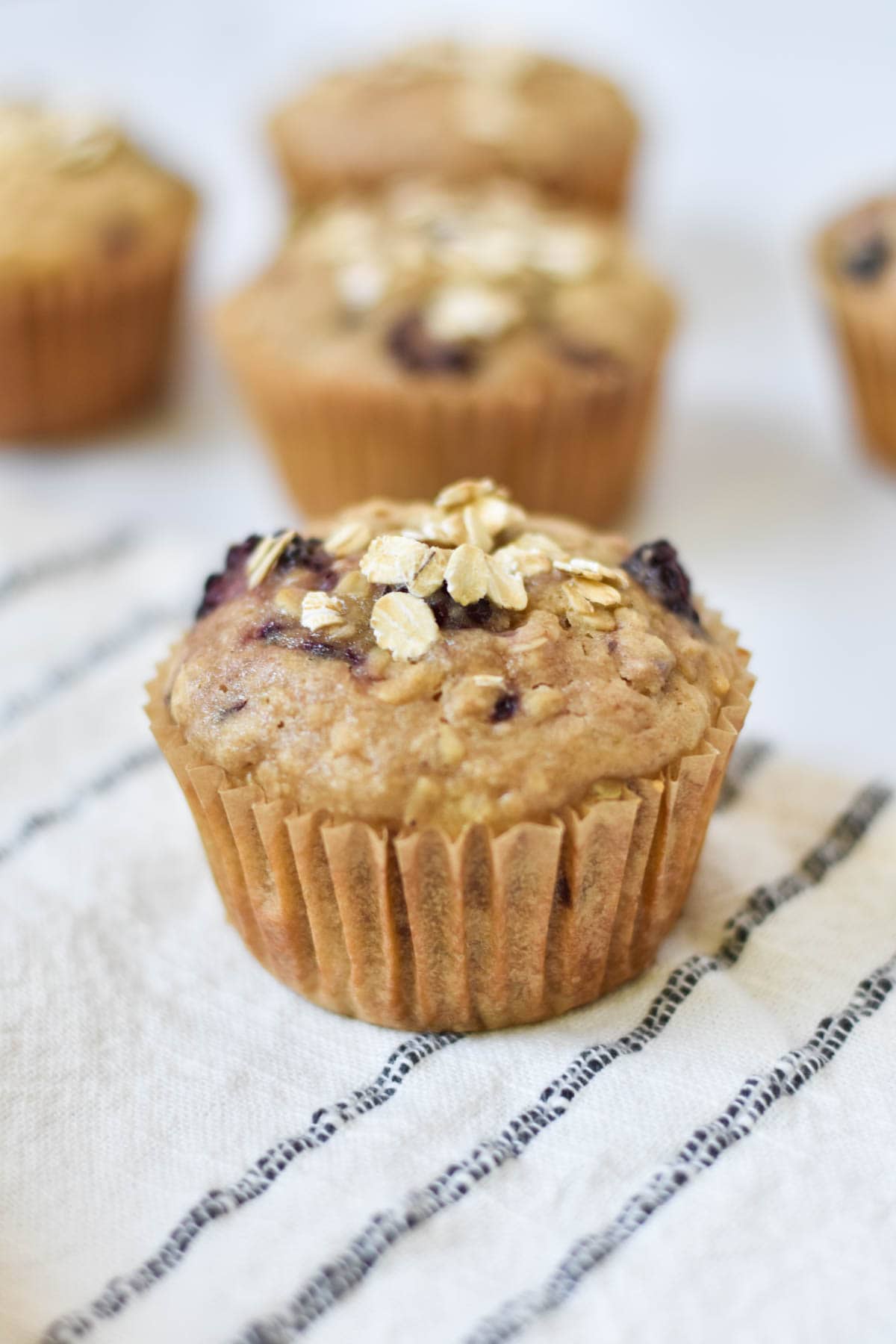 A blackberry muffin topped with oatmeal.