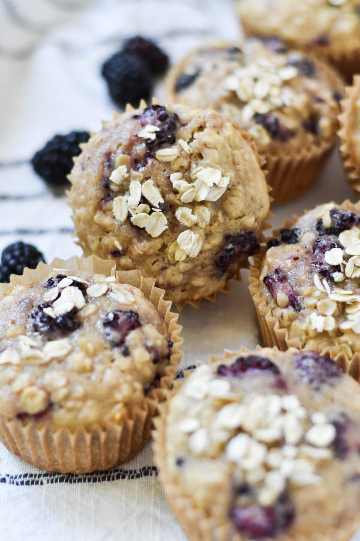 Blackberry muffins stacked on top of each other.