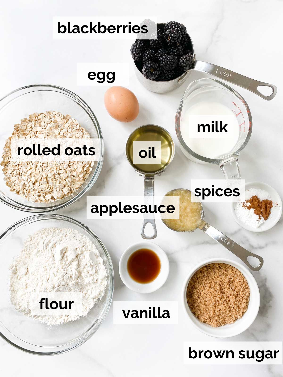 Ingredients for blackberry oatmeal muffins on a table. 