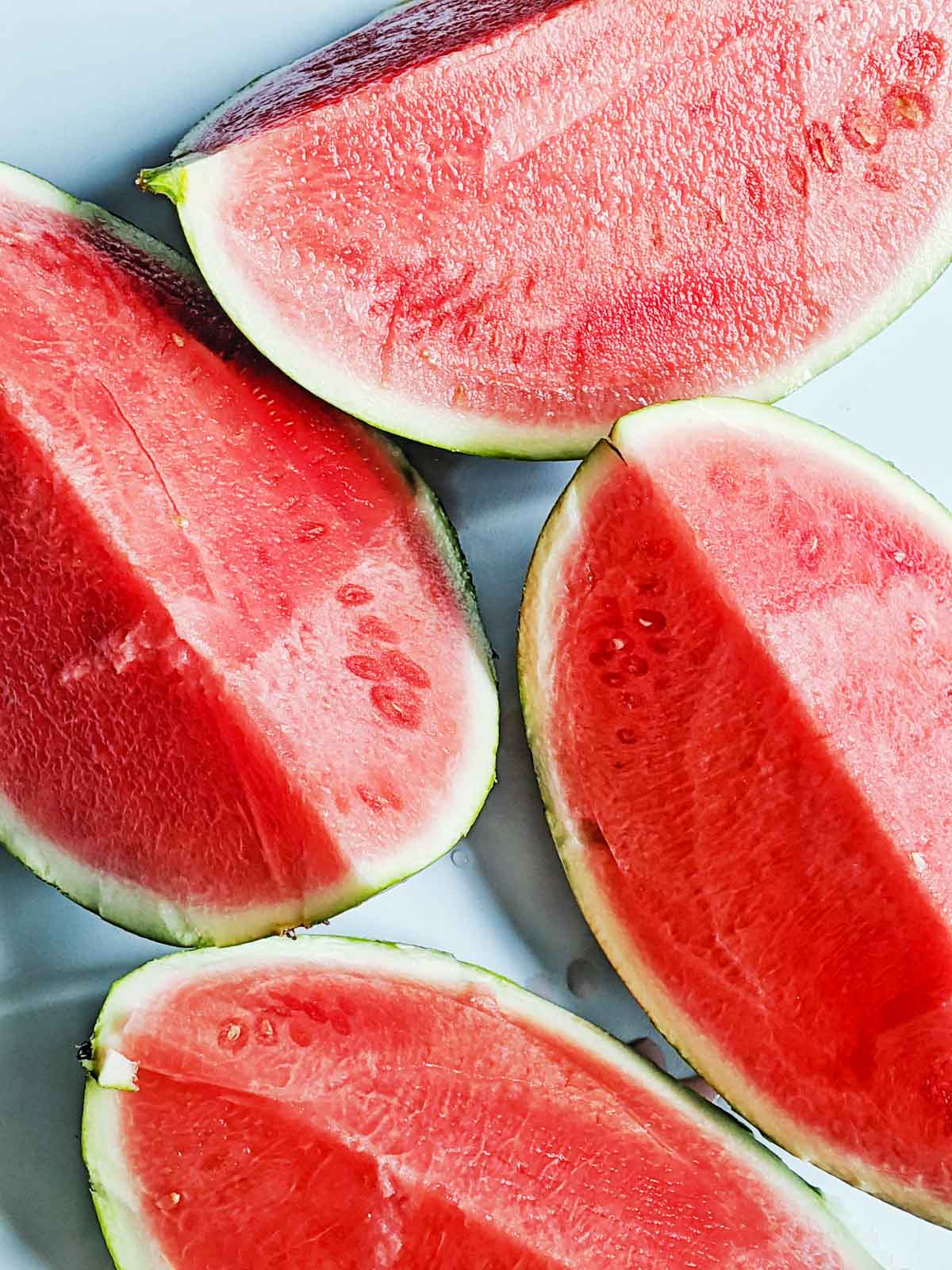 Cut watermelons on a table.