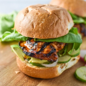 A honey chipotle chicken sandwich topped with lettuce and avocado.