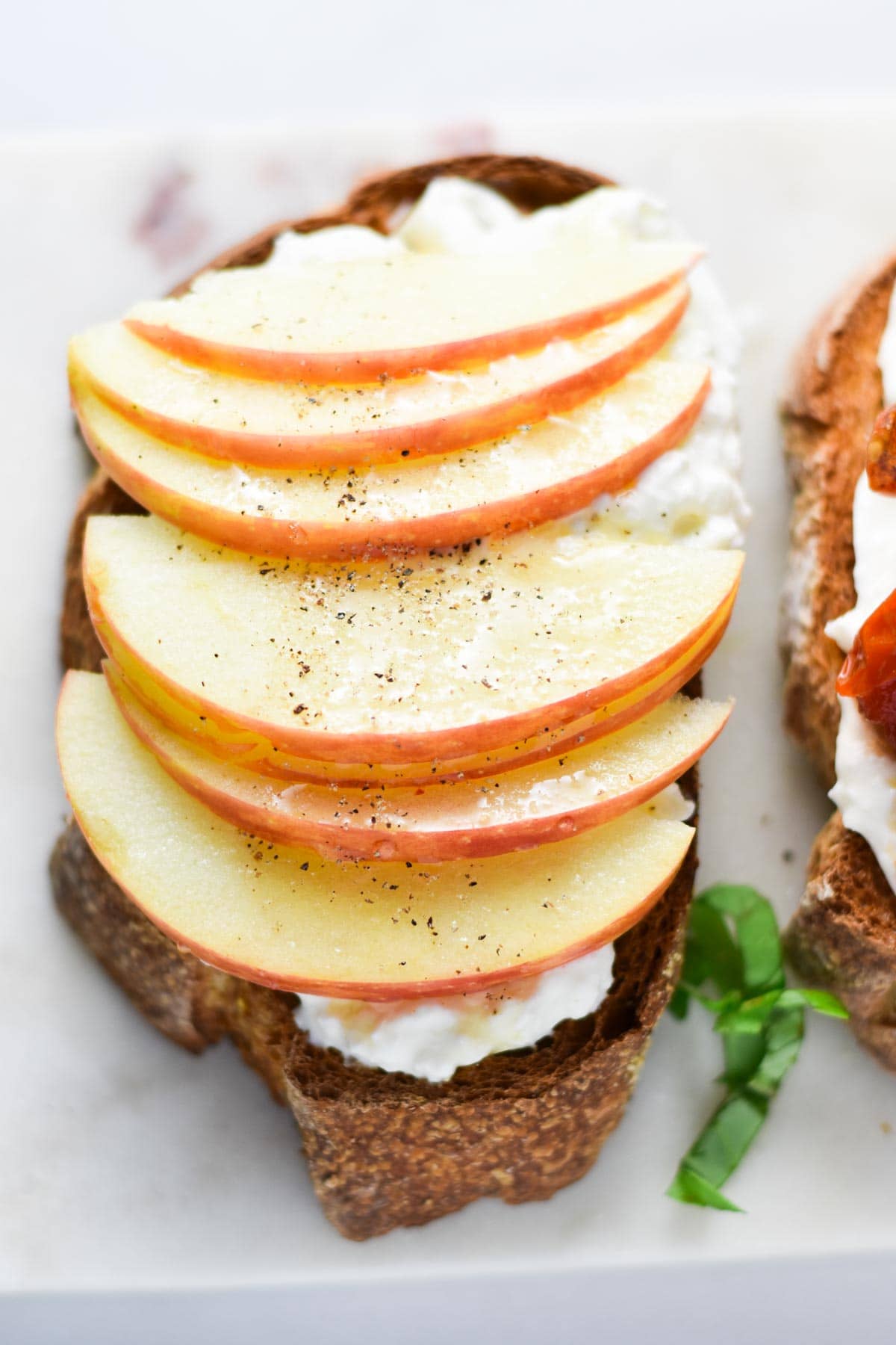 A toast topped with burrata and apples.
