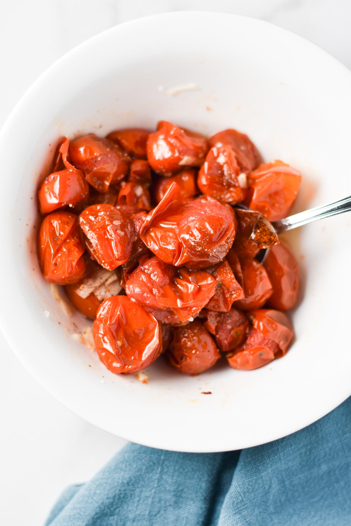 Roasted cherry tomatoes in a bowl.
