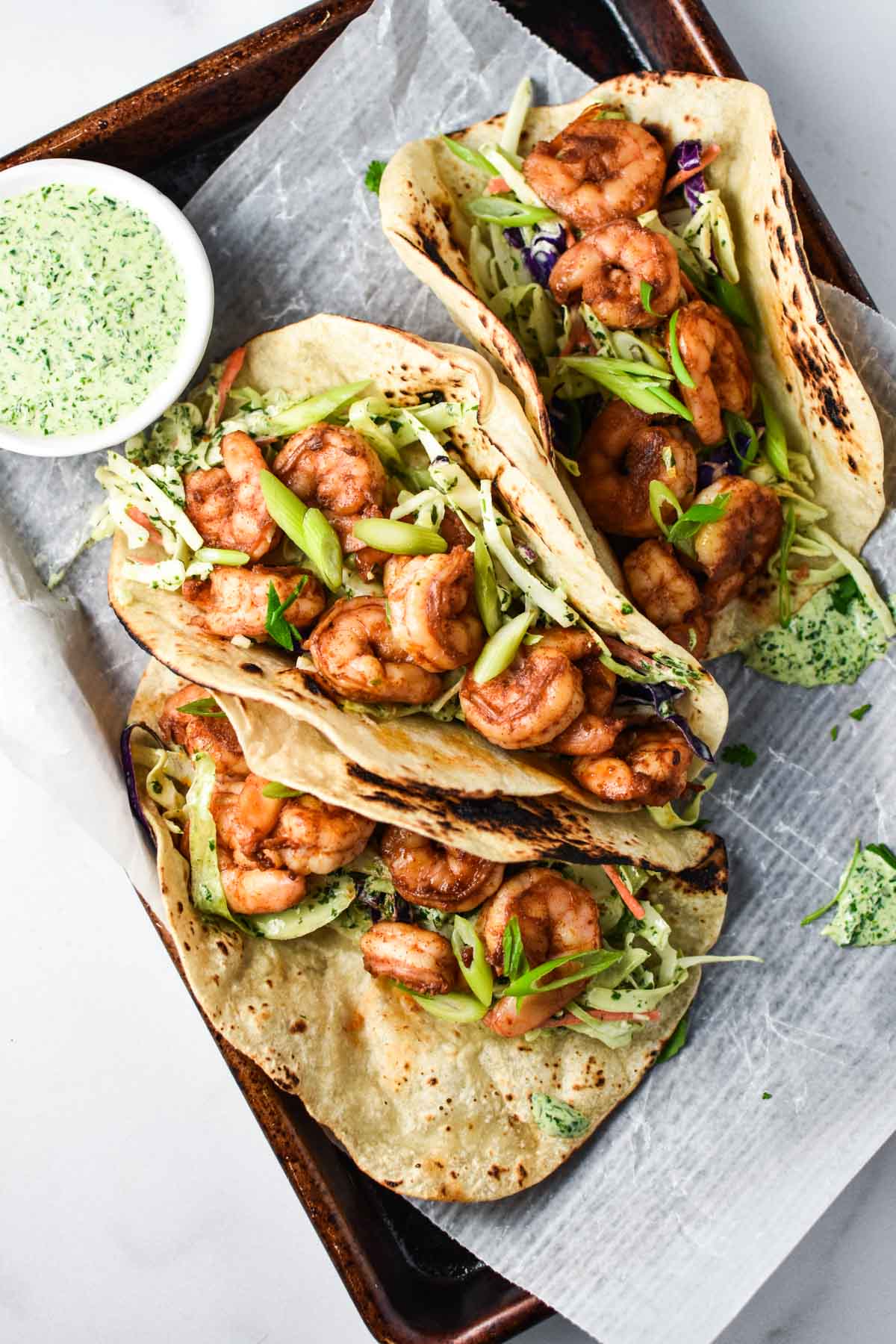 Shrimp tacos topped with cilantro slaw.