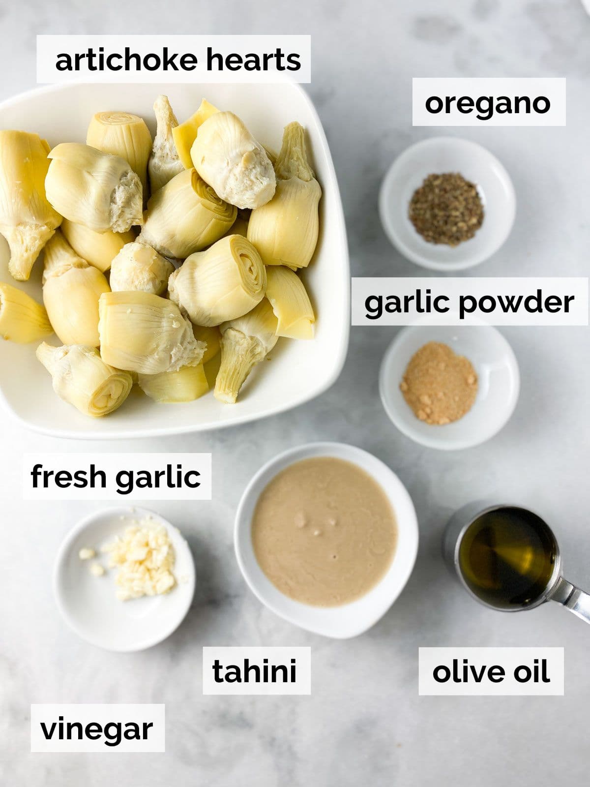 Ingredients for artichoke hummus on a table. 