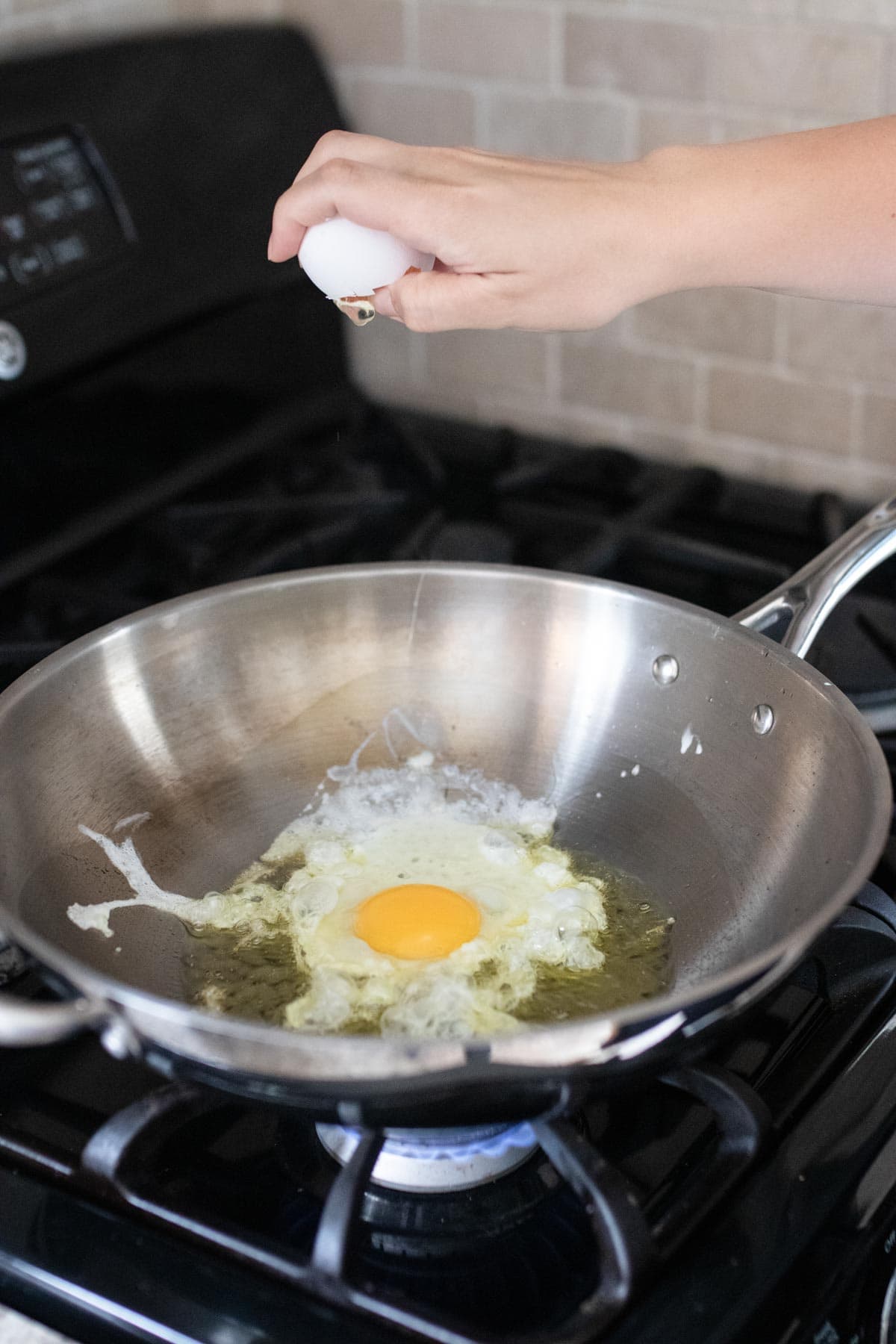 Cracking an egg into a pan.