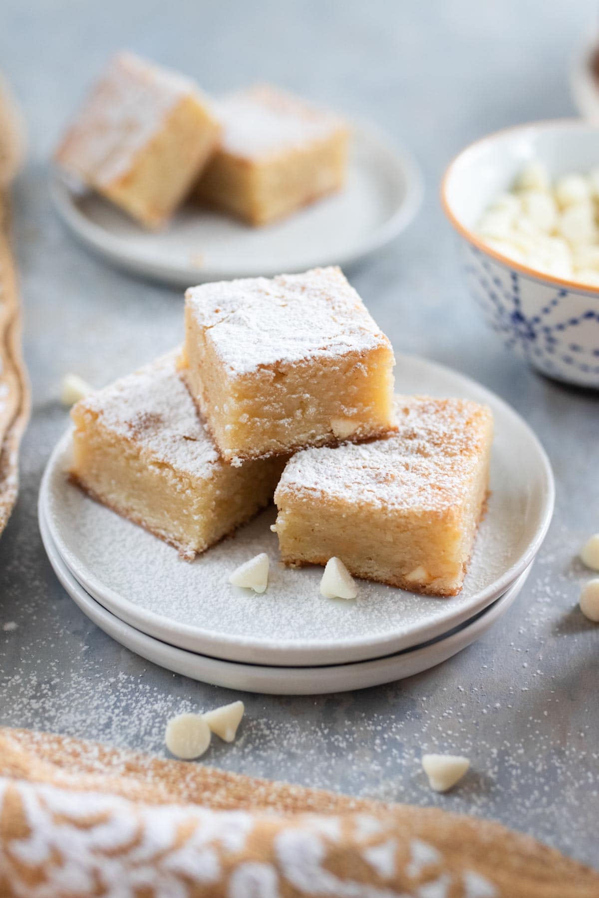 White brownie bars dusted with powdered sugar.