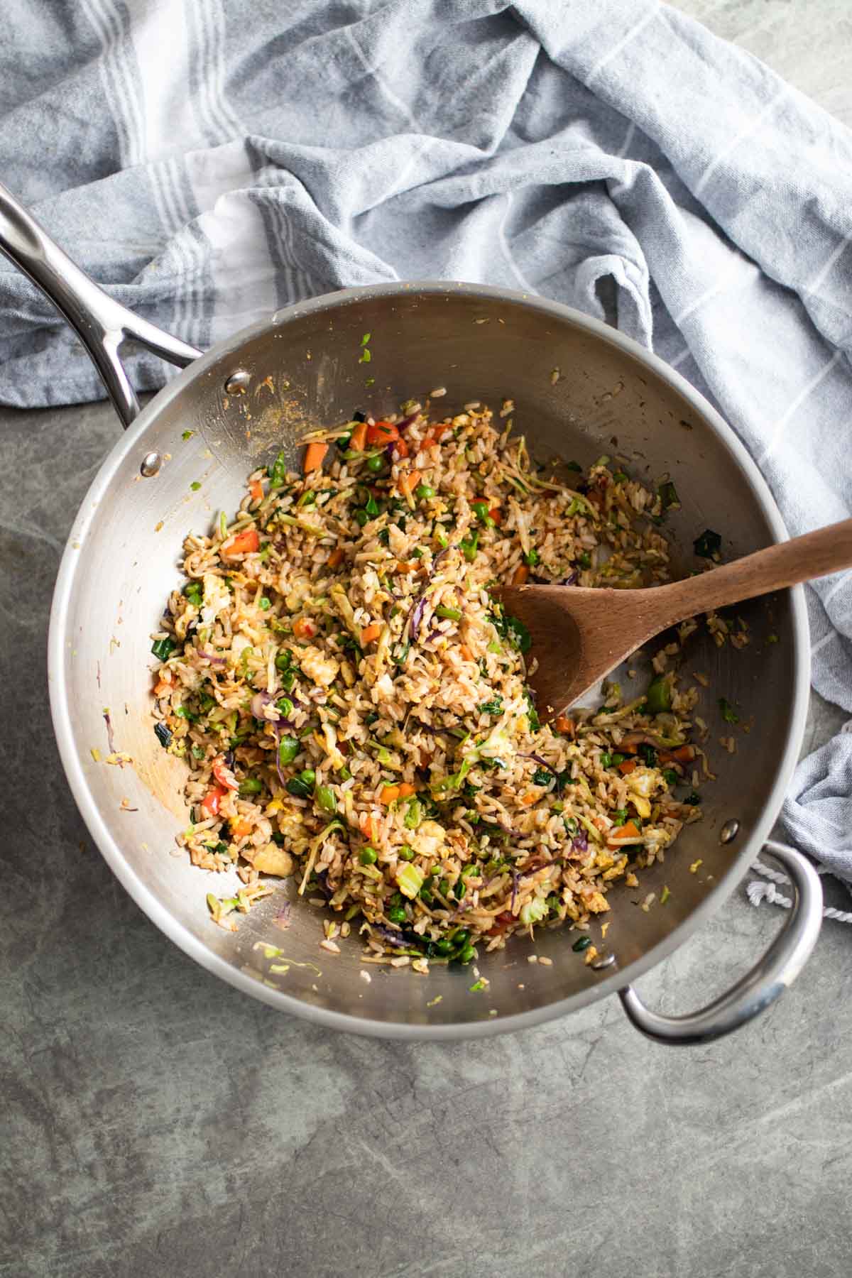 Fried rice with vegetables in a pan.