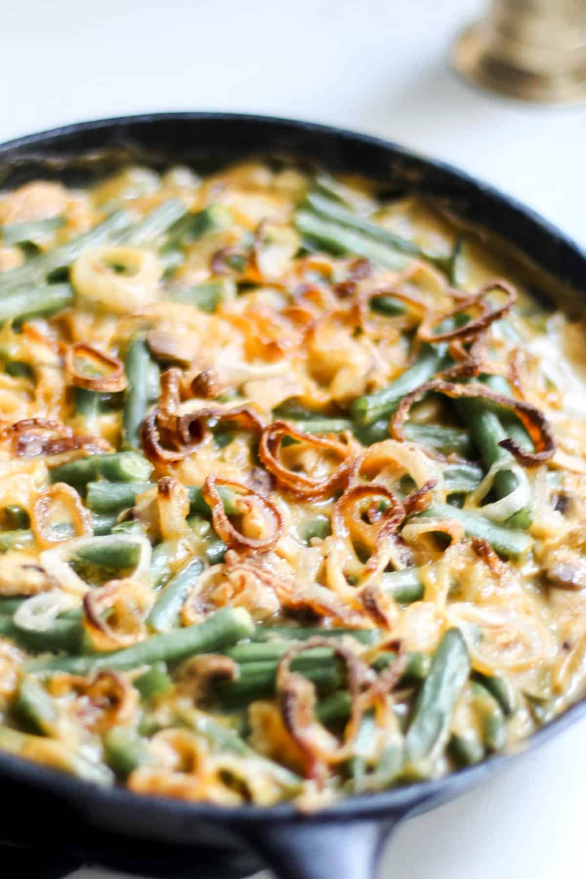 Fried shallots of top of a casserole with green beans.