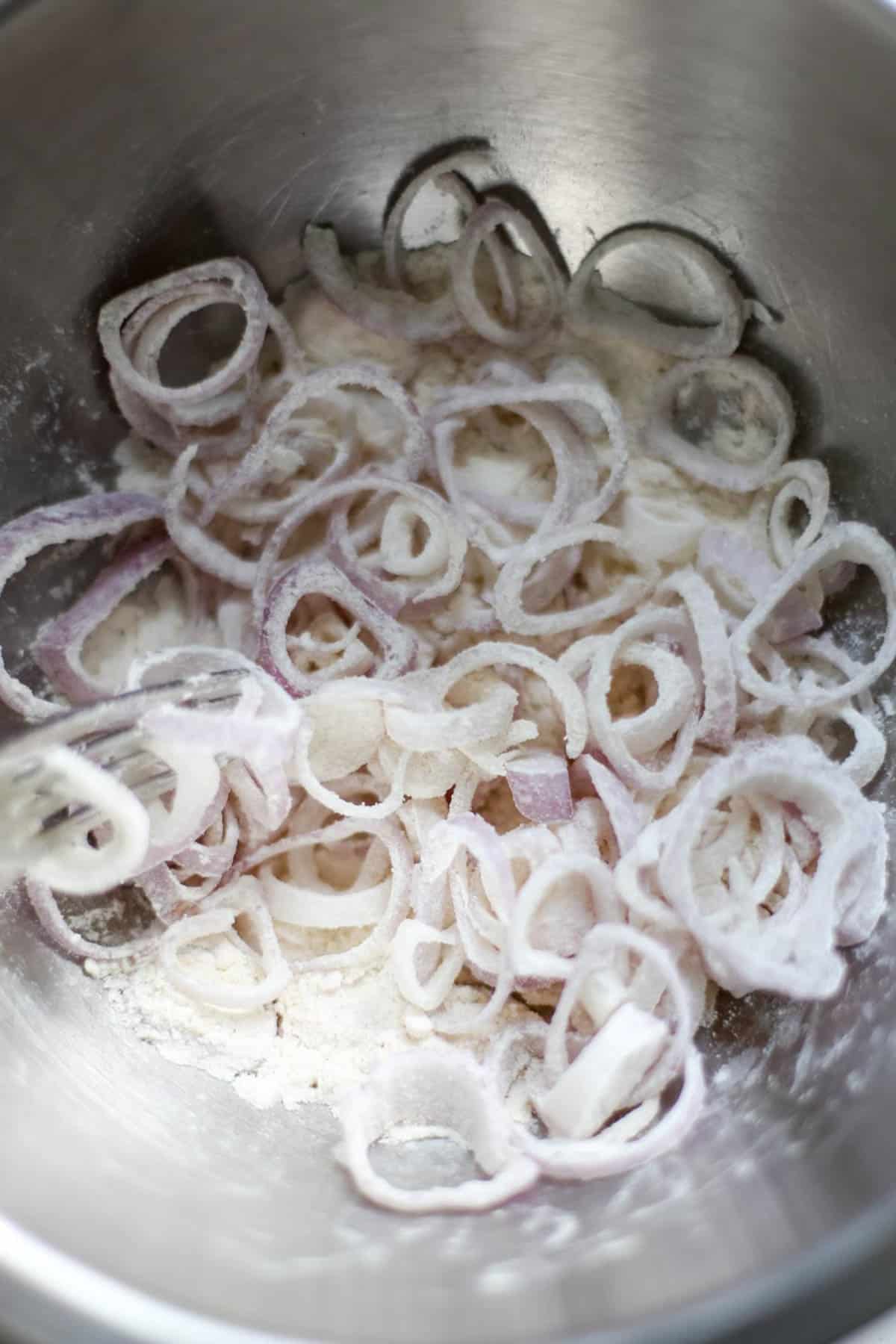 Placing shallots in flour to coat.