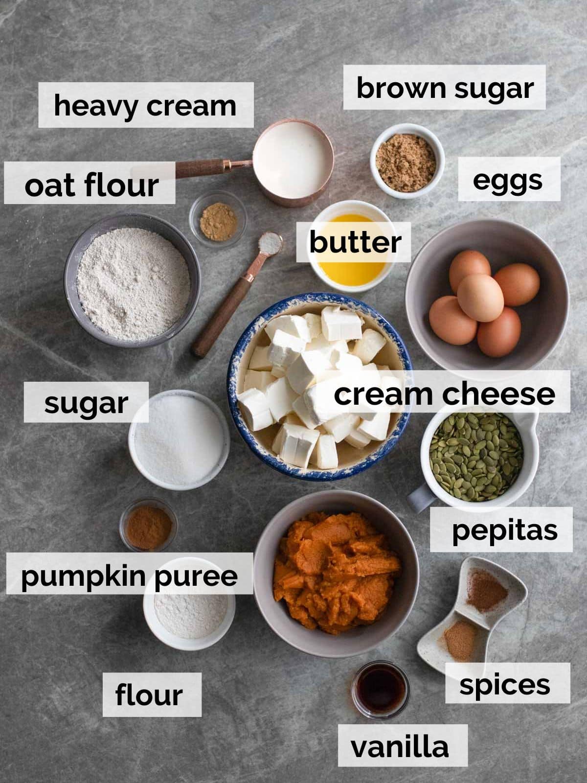 Ingredients for pumpkin cheesecake on a table.