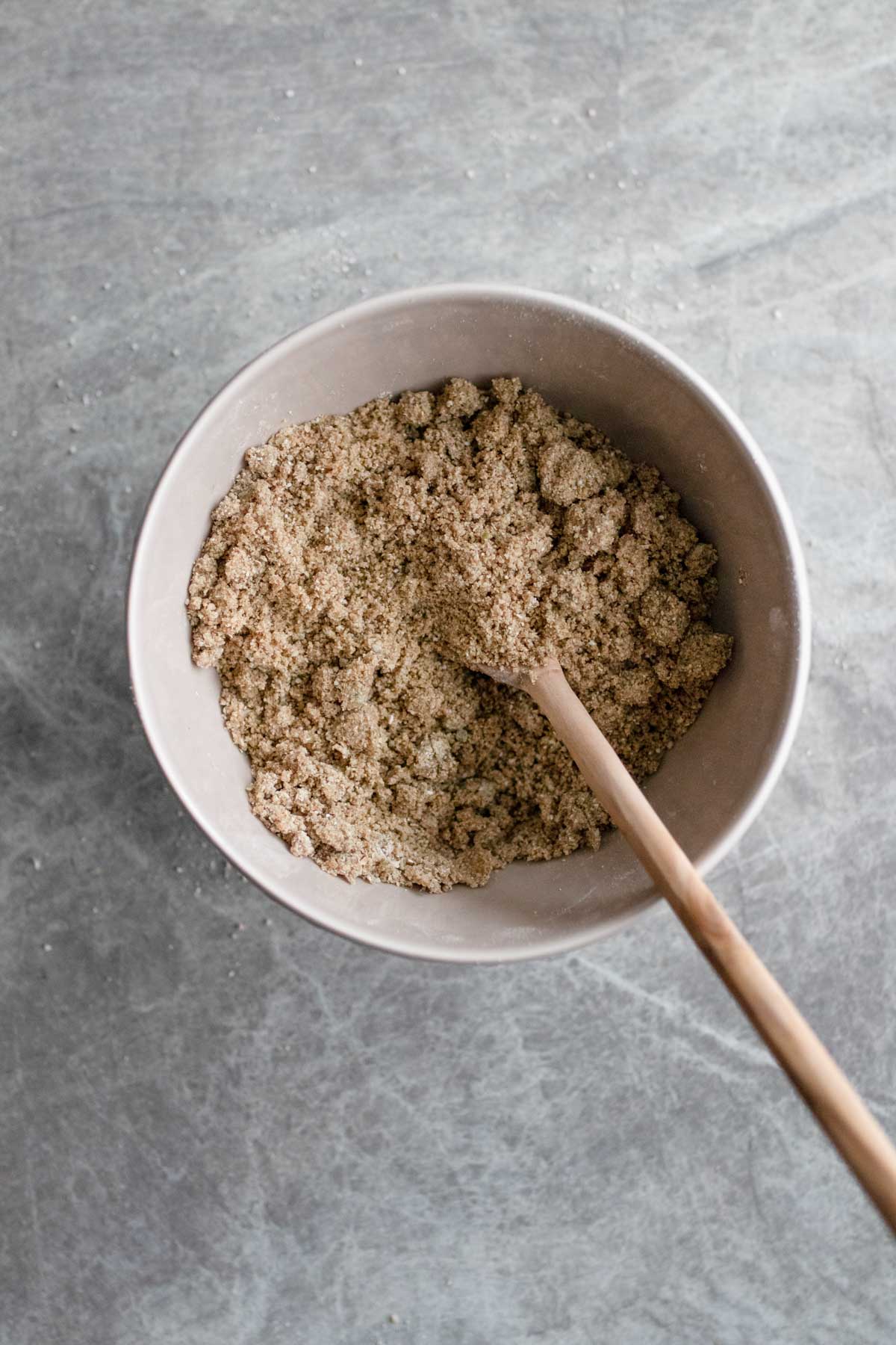 Mixing the oatmeal pepita crust for cheesecake.