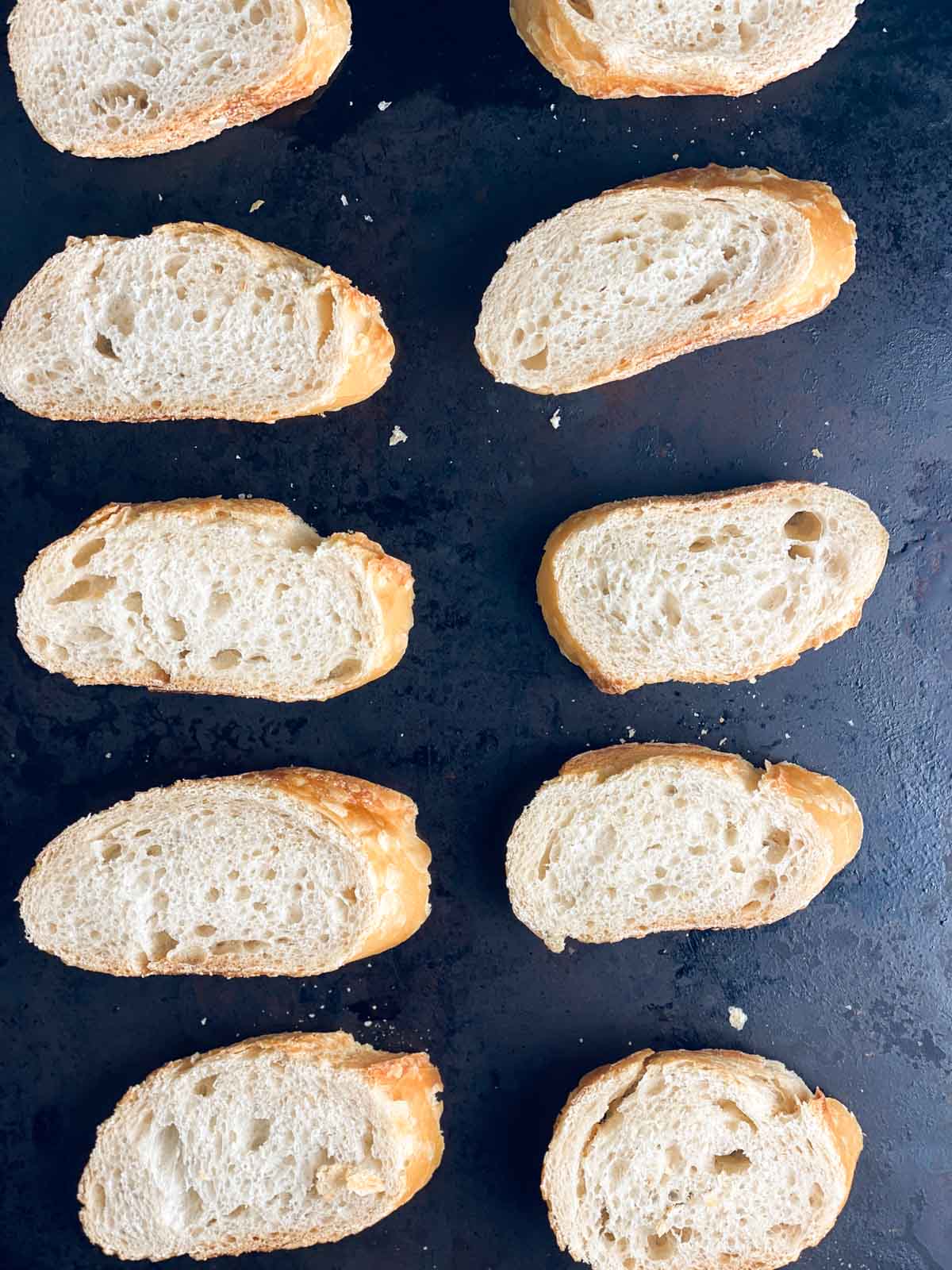 Toasting crostini on a sheet pan.