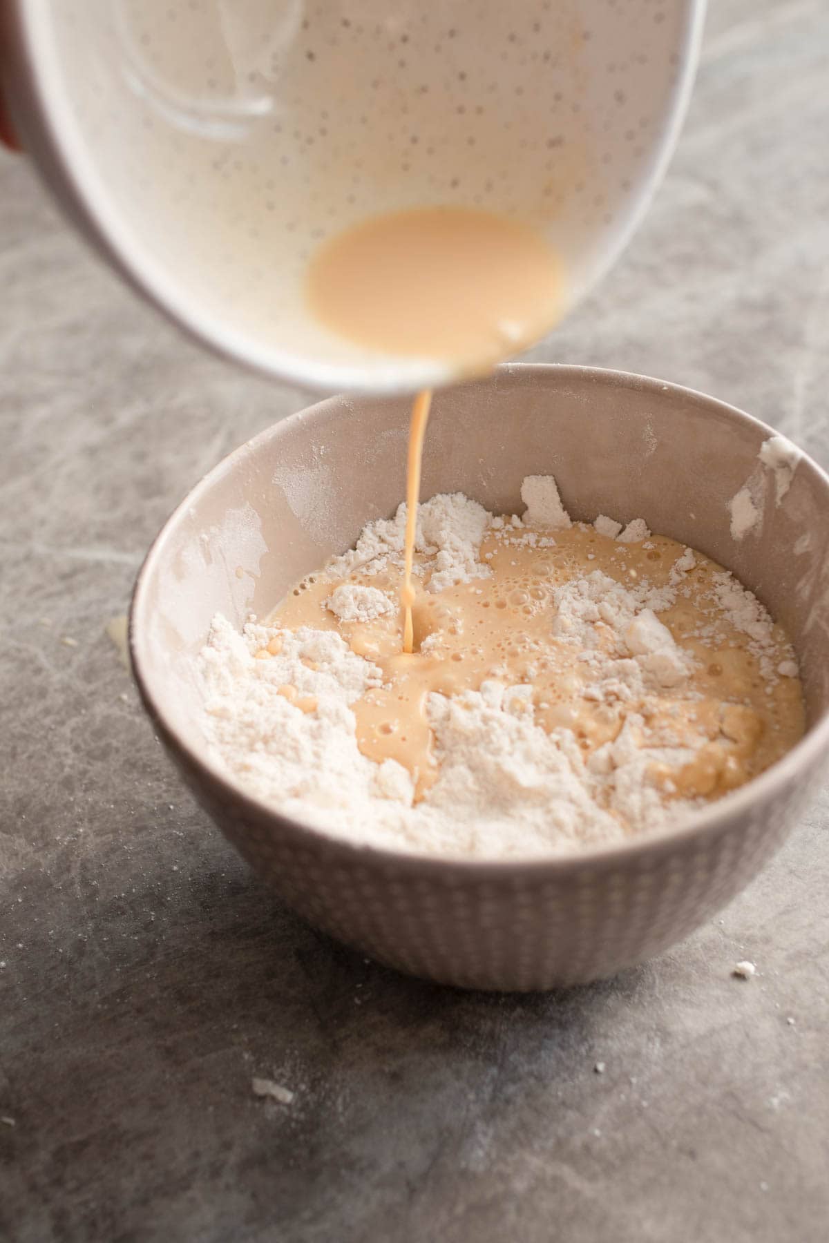 Mixing wet ingredients into the scone flour. 