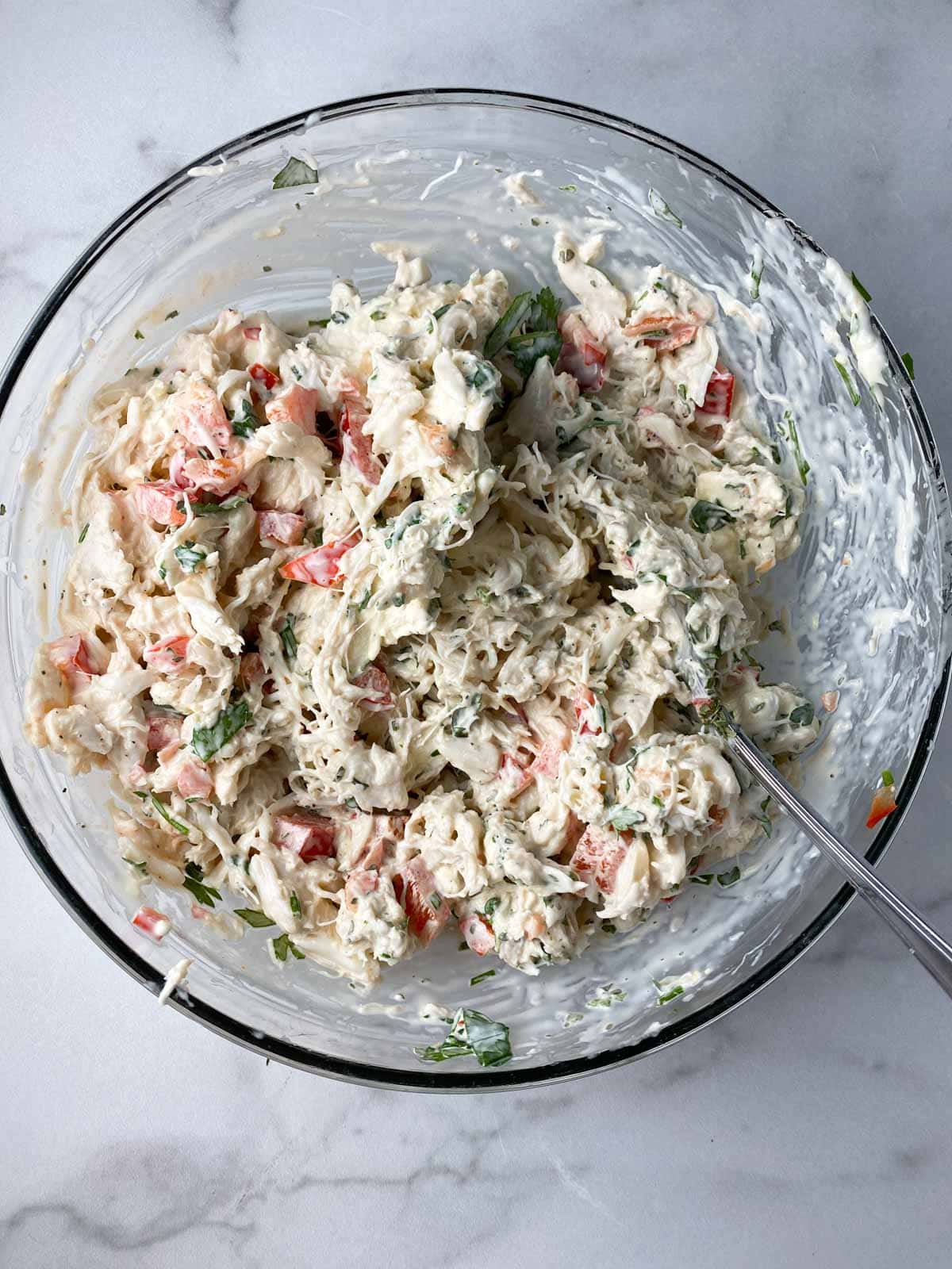 Mixture of crab and cream cheese in a bowl with spices.