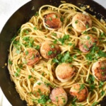 Scallop linguine with fresh parsley on top.