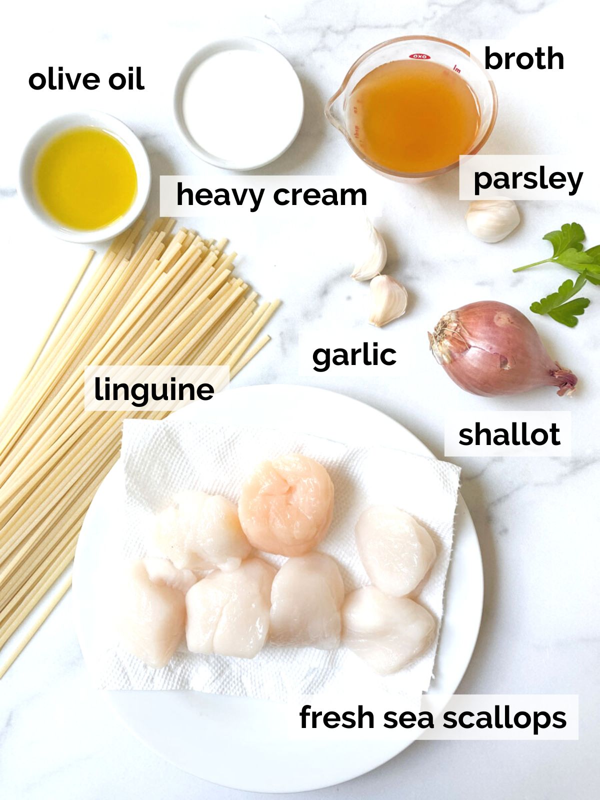 Ingredients for scallop linguine on a table.