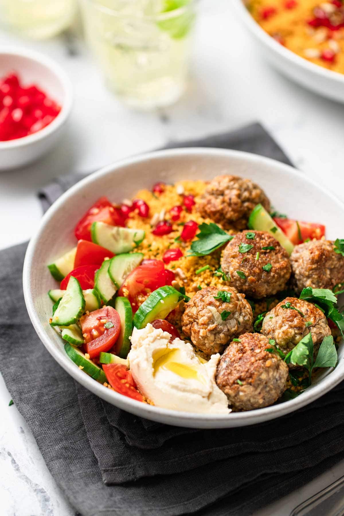 Meatballs in a bowl with hummus. 