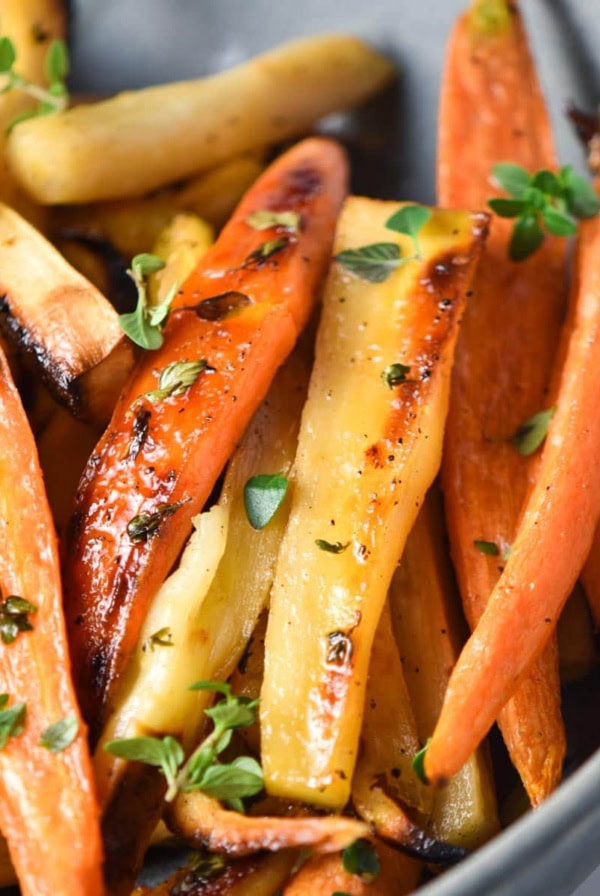 Roasted carrots and parsnips in a bowl.