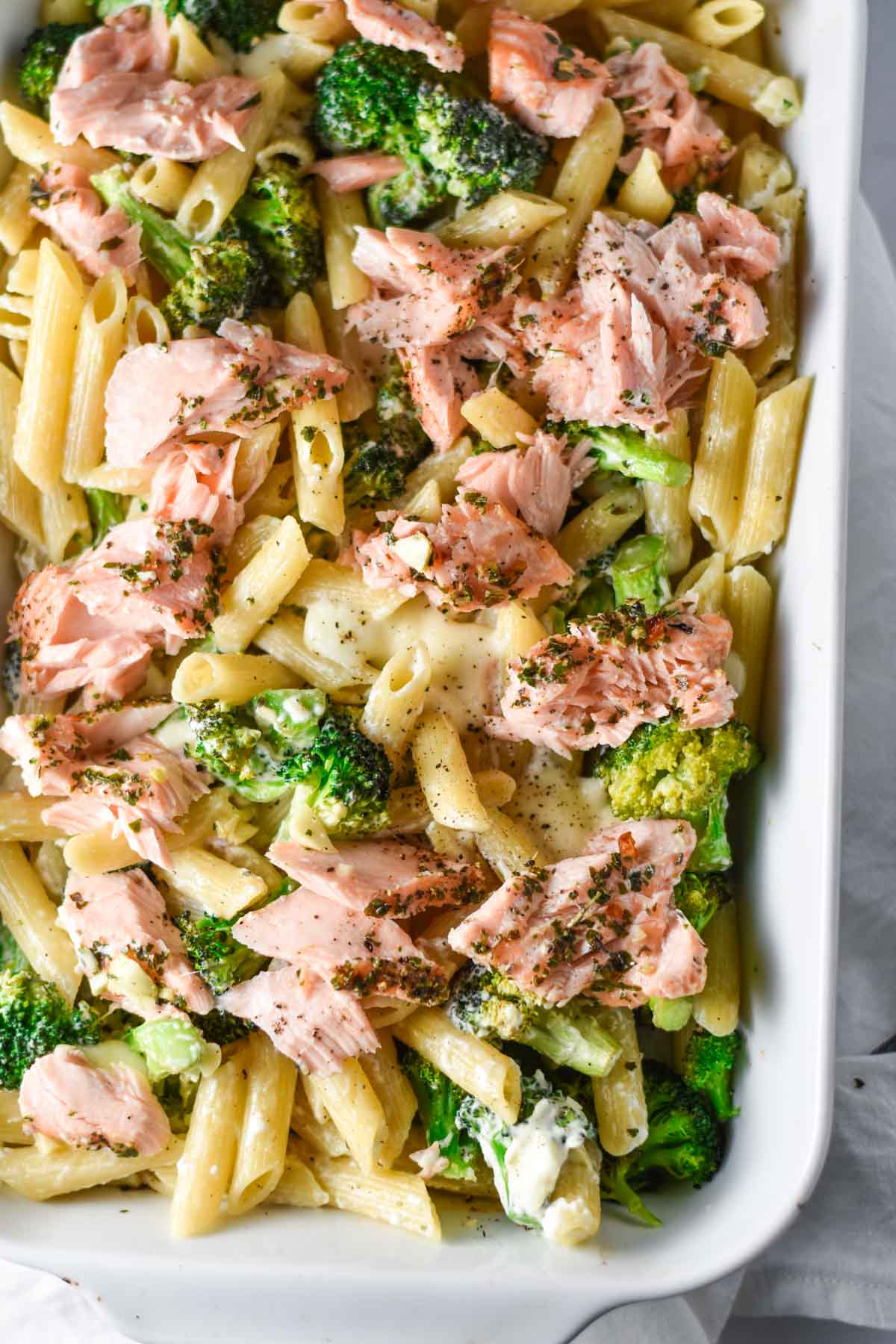Roasted salmon with broccoli and pasta in a dish.