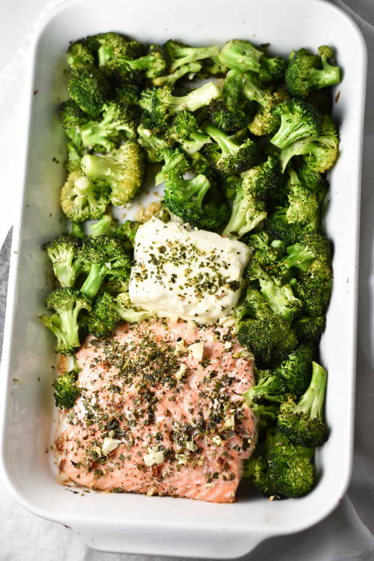 Salmon, broccoli, and cream cheese in a roasting pan after baking.