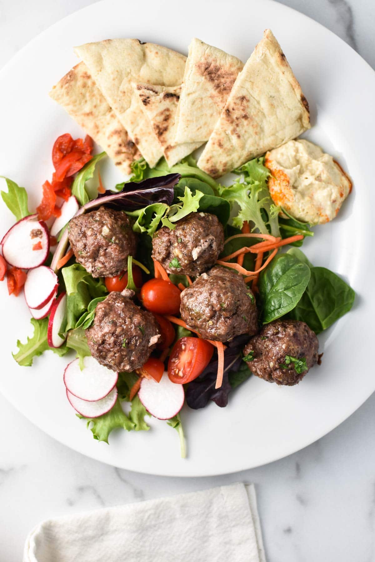 Meatballs on a greek salad.