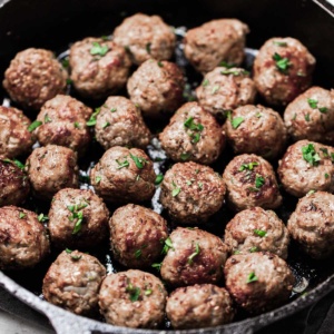 Meatballs in a cast iron pan.