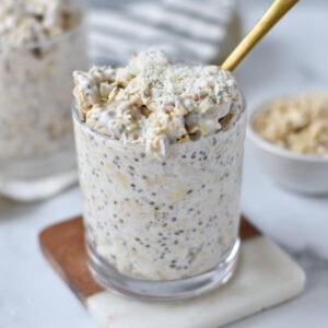 A gold spoon in coconut overnight oats.