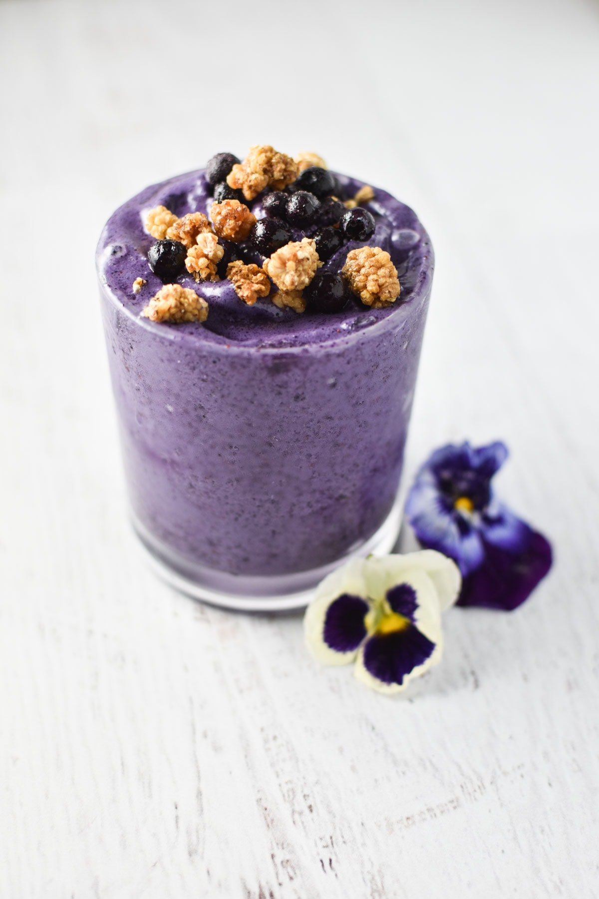 Frozen wild blueberries on top of a smoothie. 
