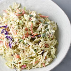 Coleslaw with apples in a serving dish.