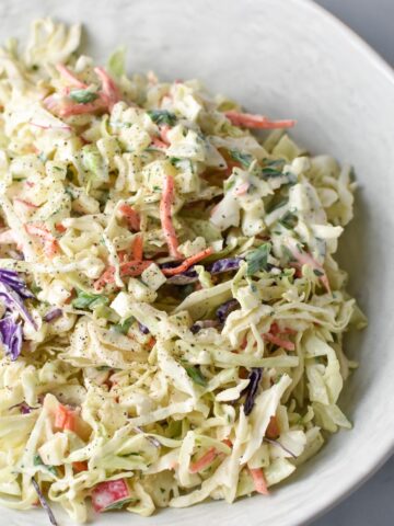 Coleslaw with apples in a serving dish.