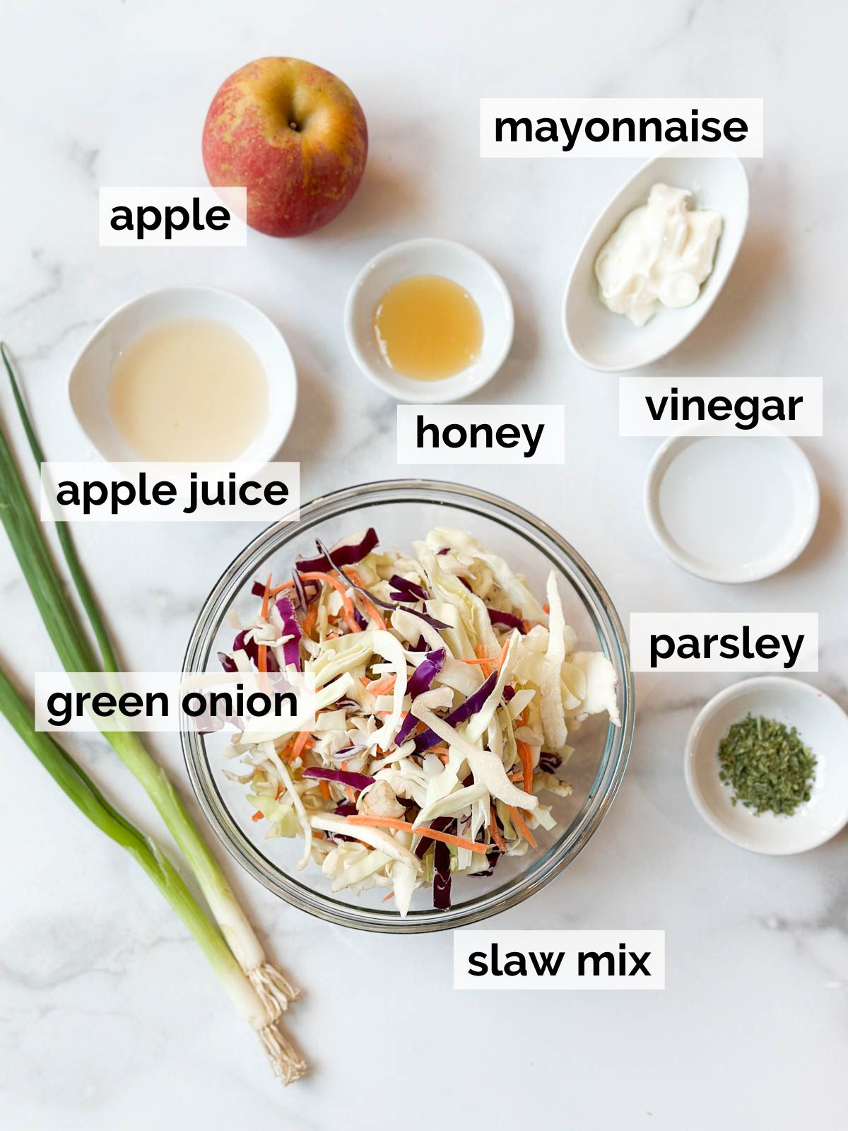 Ingredients for apple coleslaw on a table.