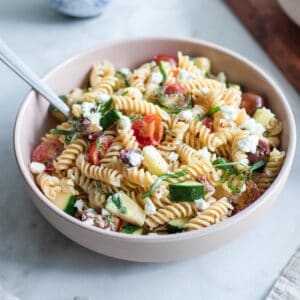 A bowl of chickpea pasta salad mixed together.