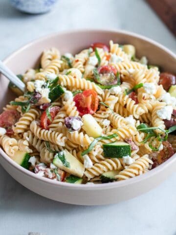 A bowl of chickpea pasta salad mixed together.