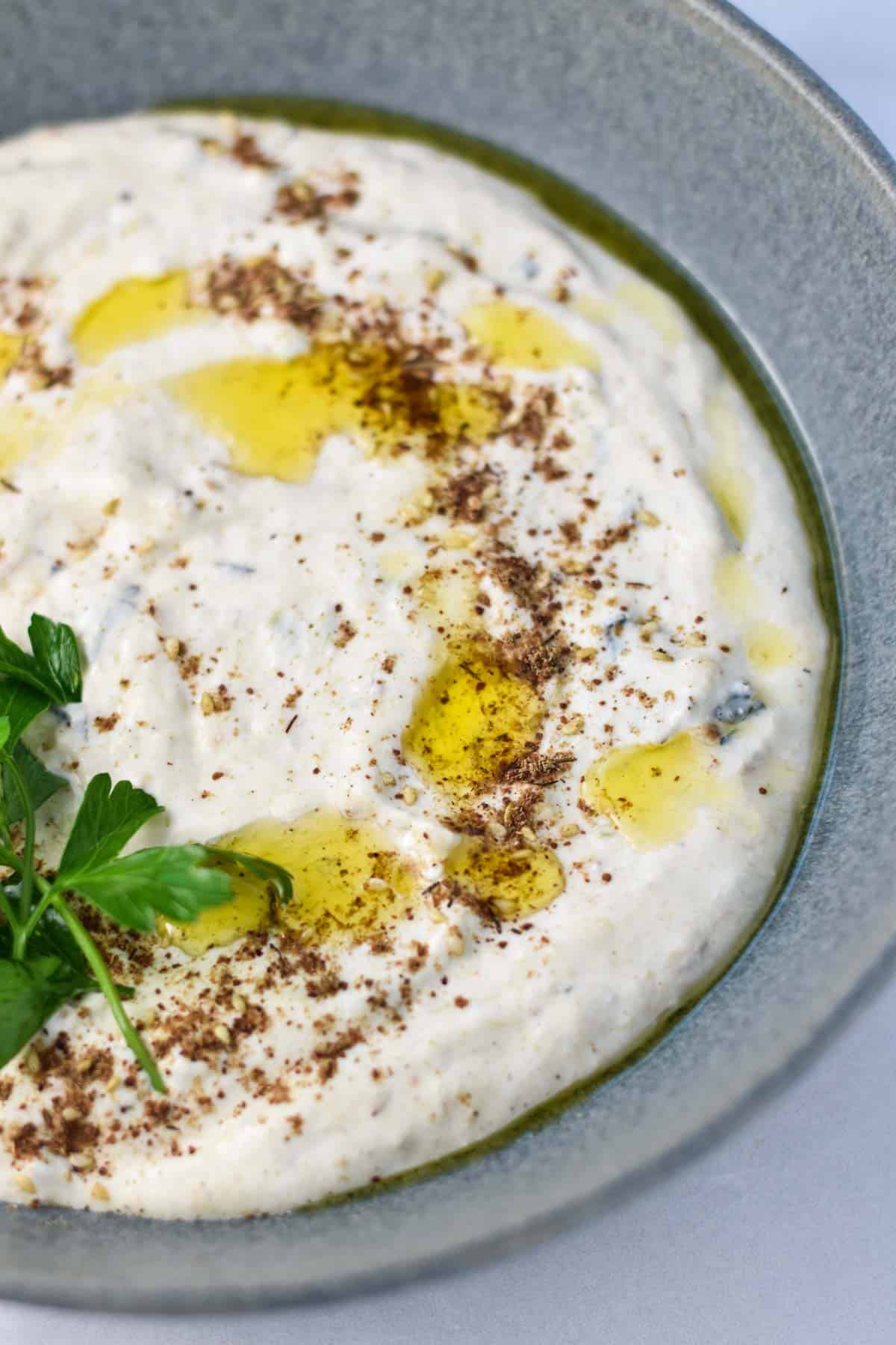 Cottage cheese dip in a bowl with olive oil on top.