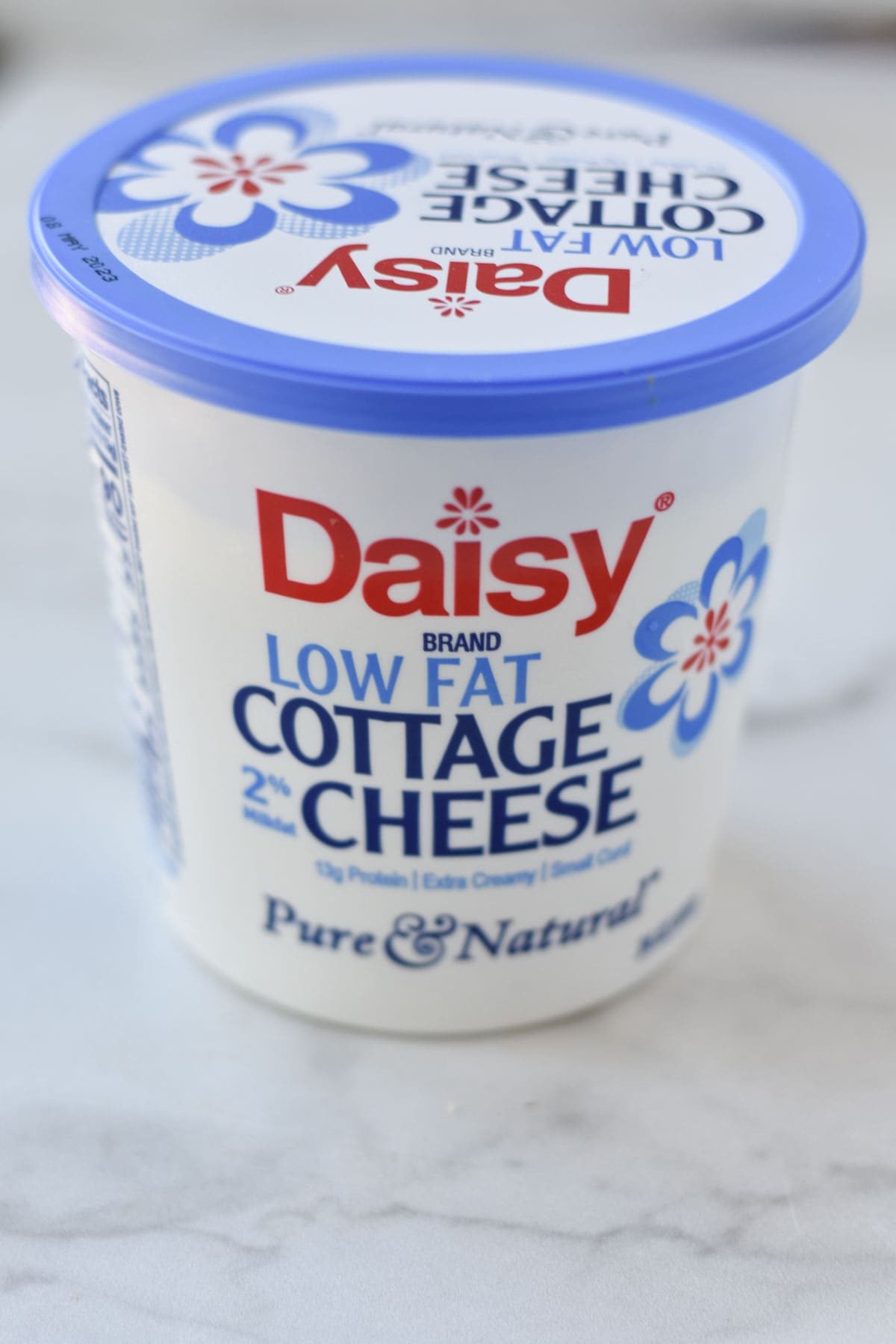 Daisy low fat cottage cheese in a container.