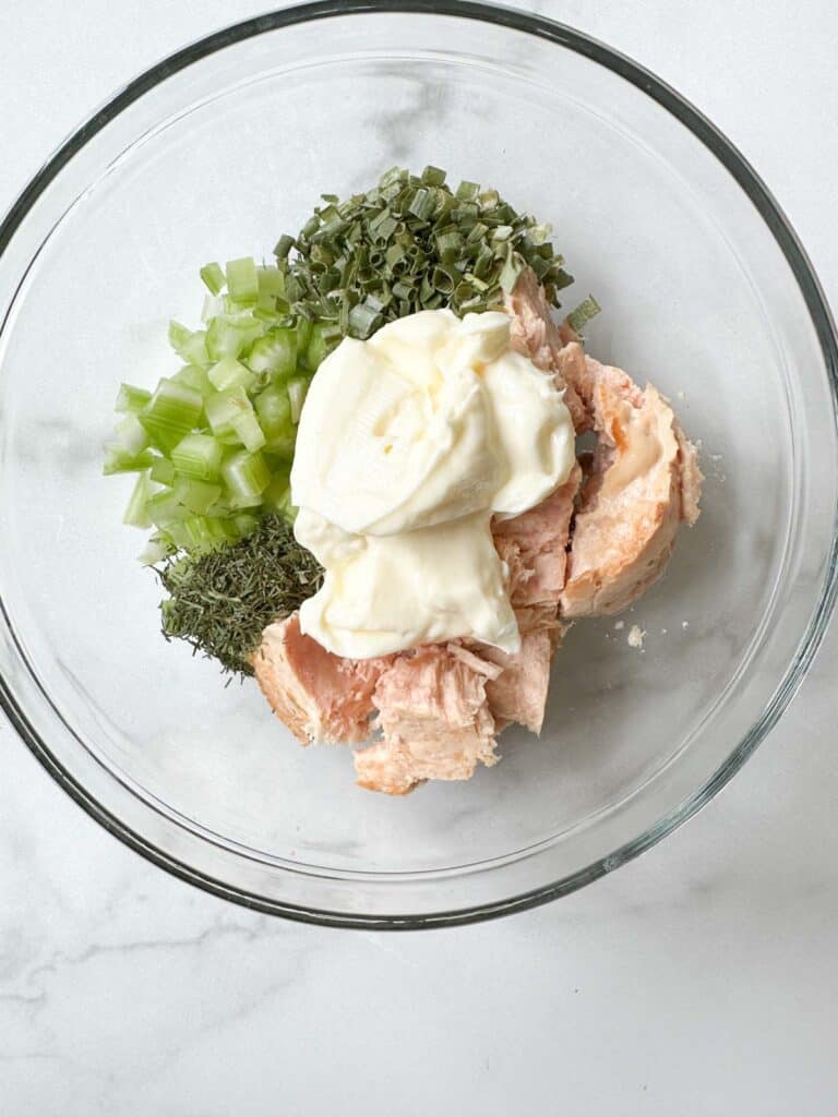Dill, tuna, mayonnaise, and celery in a bowl.