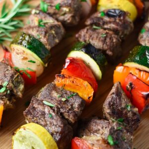 Beef kabobs with red pepper, zucchini, summer squash, and rosemary.
