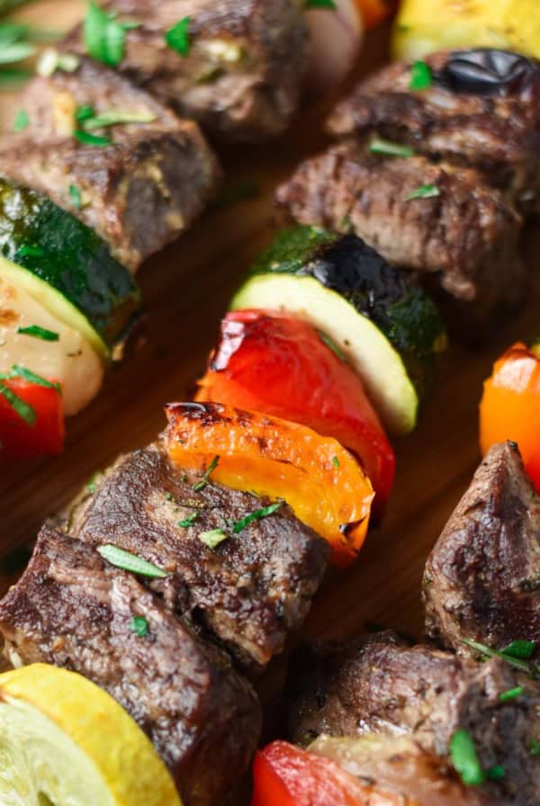 Beef kabobs with red pepper, zucchini, summer squash, and rosemary.