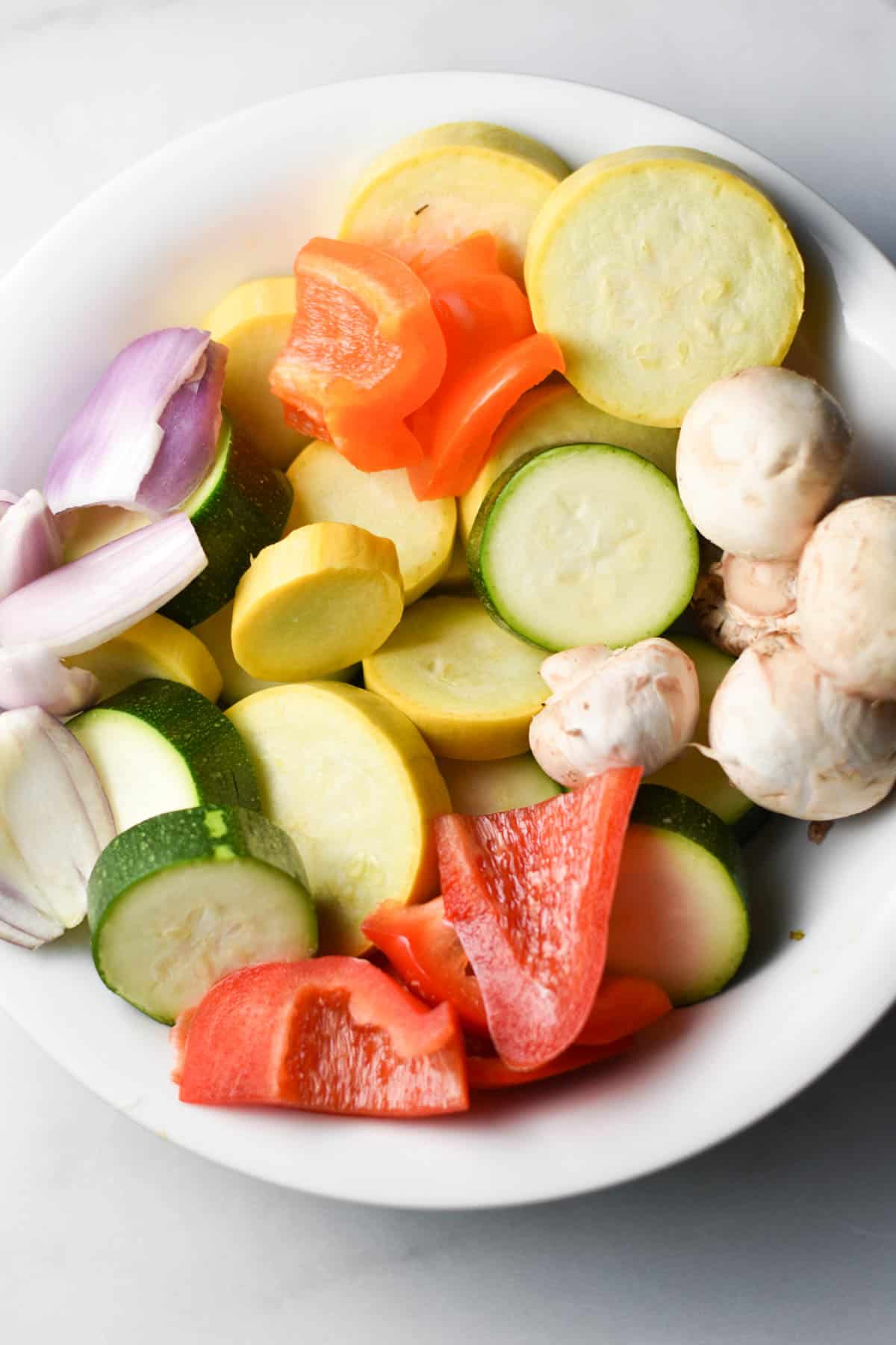 Assorted vegetables in a white bowl.