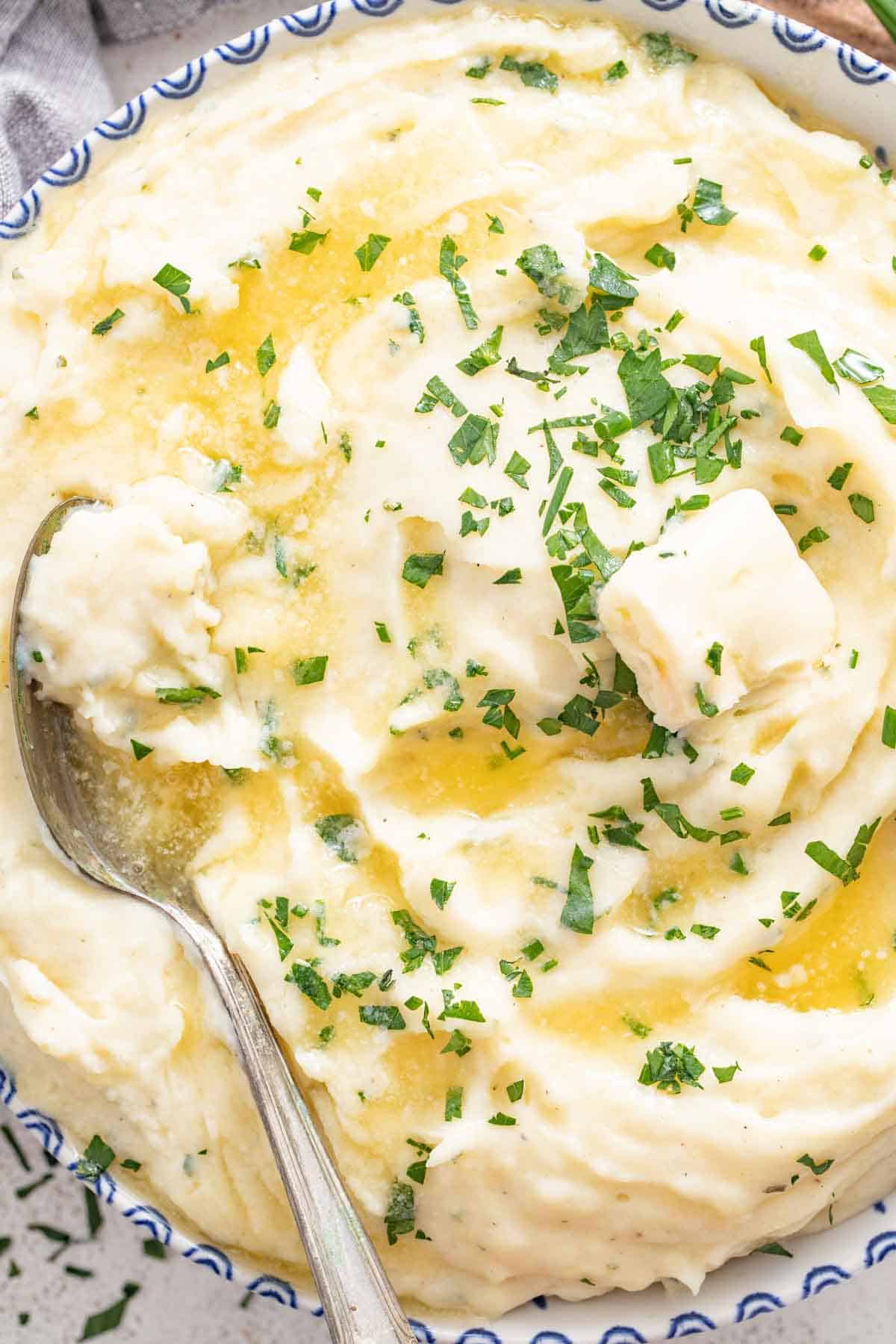 A close up shot of melted butter on top of mashed potatoes.