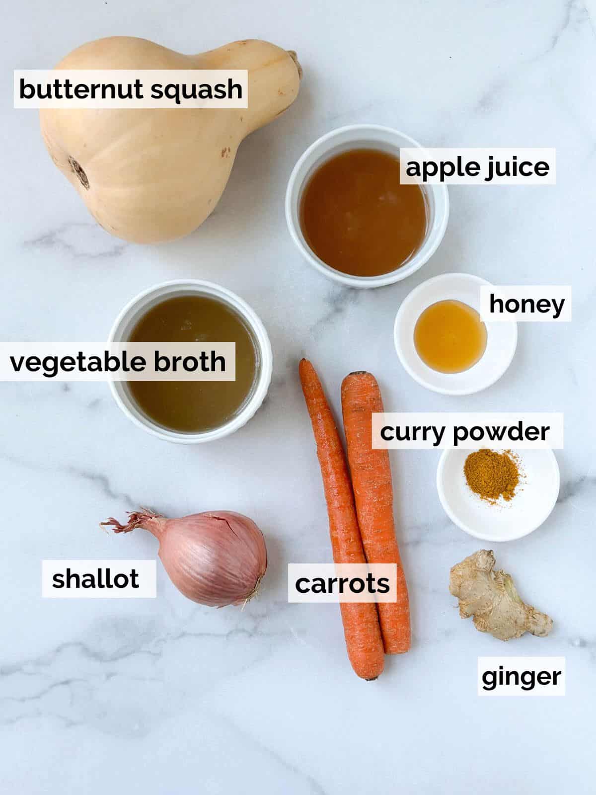 Ingredients for instant pot butternut squash soup on a marble background.
