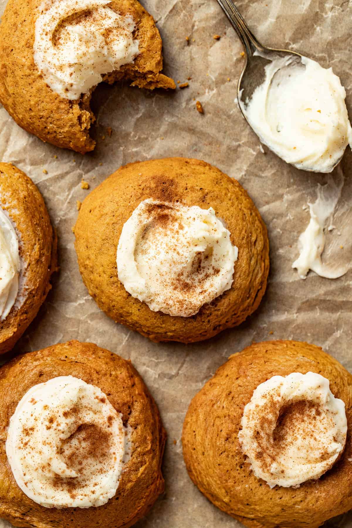Putting frosting into a pumpkin thumbprint cookie.