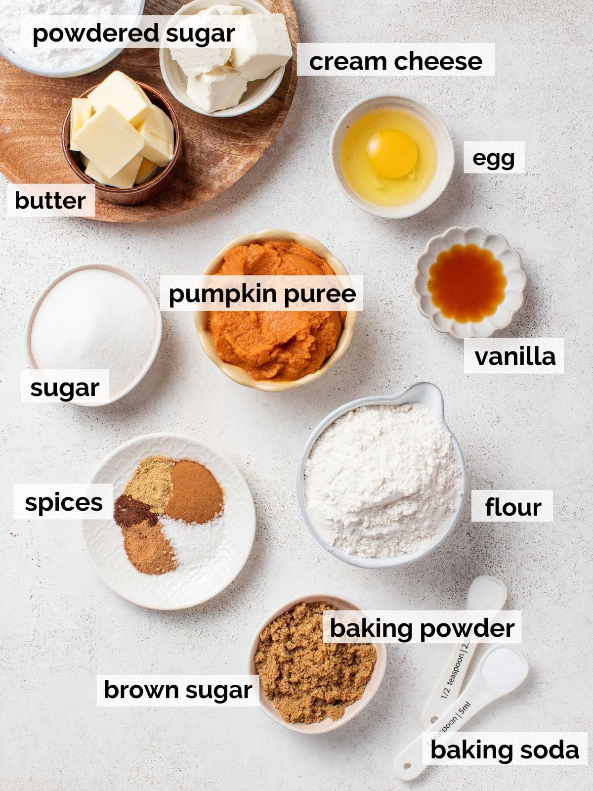 Ingredients for cookies including cream cheese, pumpkin puree, spices, and more.