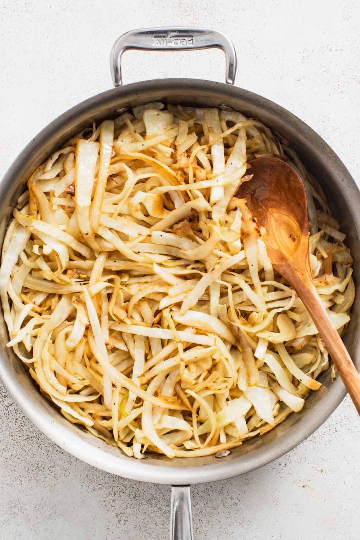 Saut&eacute;ed cabbage in a large pan.