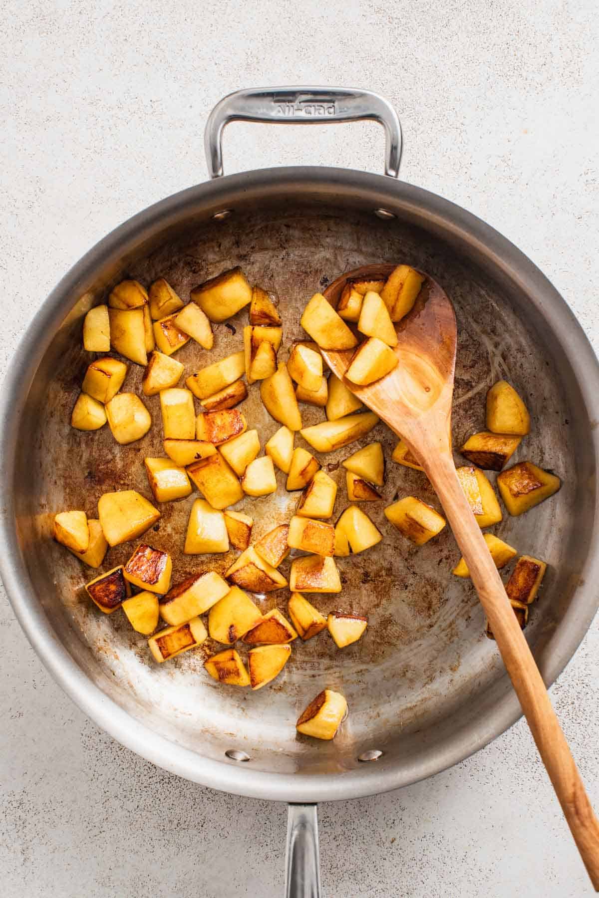 Saut&eacute;ed apples in a large pan.