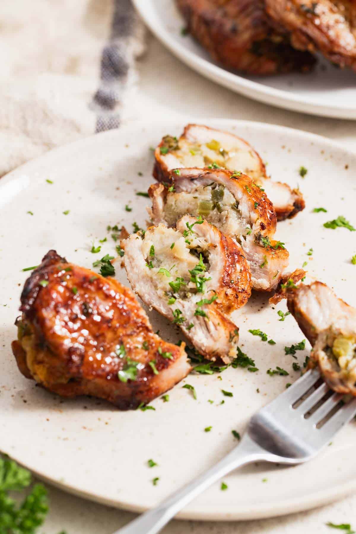 Golden brown sliced pork chops stuffed with a bread filling.