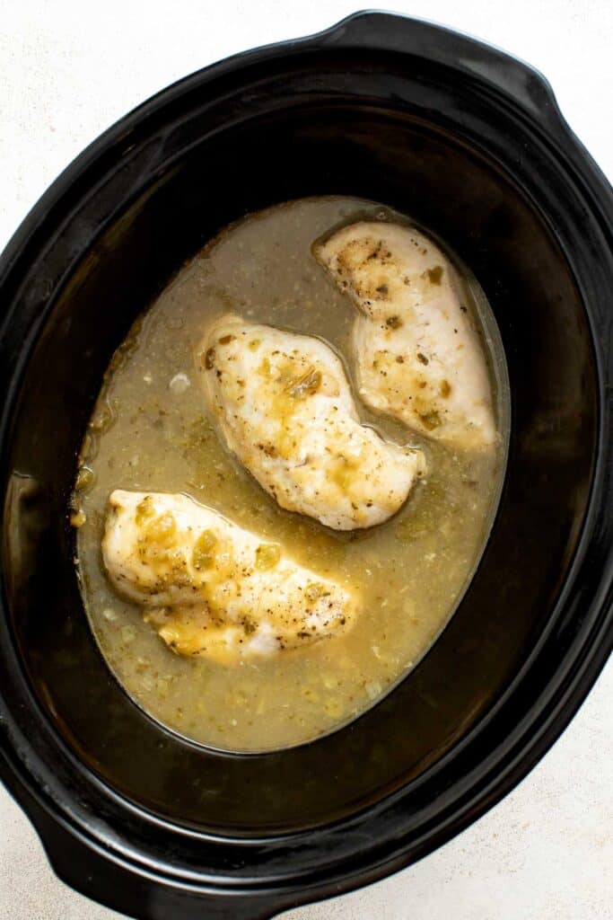 Chicken breasts and salsa in a crockpot.